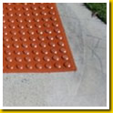 Red Stikcrete tactiles inset in concrete footpath