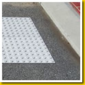White Stikcrete tactiles inset in island crossing